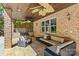 An outdoor seating area with brick columns, ceiling fans and comfortable wicker furniture at 1009 Seminole Dr, Waxhaw, NC 28173