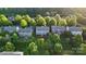 Aerial view showcases the home's backyard with mature trees and patio furniture for outdoor living at 10115 Paxton Run Rd, Charlotte, NC 28277