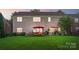 Well-manicured backyard with lush lawn, outdoor seating area, and mature landscaping, perfect for relaxation and entertaining at 10115 Paxton Run Rd, Charlotte, NC 28277