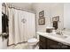 Cozy bathroom with a shower, white vanity, and elegant framed art at 10115 Paxton Run Rd, Charlotte, NC 28277