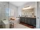Bright bathroom with a soaking tub, frameless shower, double vanity, and subway tile at 10115 Paxton Run Rd, Charlotte, NC 28277