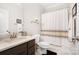 Cozy bathroom featuring tile floors, updated vanity, and shower with decorative curtain at 10115 Paxton Run Rd, Charlotte, NC 28277