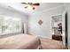 Bedroom with window blinds, full-length mirror, and nearby access to second floor at 10115 Paxton Run Rd, Charlotte, NC 28277