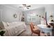 Bright, well-lit bedroom featuring a bed, desk, bookshelf, and a ceiling fan at 10115 Paxton Run Rd, Charlotte, NC 28277