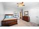 Comfortable bedroom with wood furnishings, neutral tones, and a ceiling fan at 10115 Paxton Run Rd, Charlotte, NC 28277