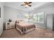 Serene bedroom with a ceiling fan, window with blinds, and decorative accents at 10115 Paxton Run Rd, Charlotte, NC 28277