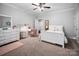 Charming bedroom with ceiling fan, plush carpet, and cute desk area at 10115 Paxton Run Rd, Charlotte, NC 28277