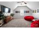 Upstairs bonus room offers ample seating, modern decor, and a cozy atmosphere at 10115 Paxton Run Rd, Charlotte, NC 28277