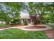 Well-maintained community entrance with lush landscaping, stone accents, and winding pathway at 10115 Paxton Run Rd, Charlotte, NC 28277