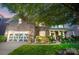 Charming home with stone facade, well-manicured landscaping, and a two-car garage at 10115 Paxton Run Rd, Charlotte, NC 28277