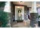Inviting front porch with stone pillars, decorative wreath, and a welcoming atmosphere at 10115 Paxton Run Rd, Charlotte, NC 28277