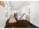 Upstairs hallway boasts hardwood floors and leads to well-lit rooms at 10115 Paxton Run Rd, Charlotte, NC 28277