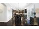 Eat-in kitchen with dark wood floors, cabinets, stainless steel appliances, and granite countertops at 10115 Paxton Run Rd, Charlotte, NC 28277