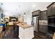 Open-concept kitchen features granite countertops, an island with seating, and stainless appliances at 10115 Paxton Run Rd, Charlotte, NC 28277