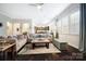 Spacious living room with recessed lights, dark wood floors, and a large area rug at 10115 Paxton Run Rd, Charlotte, NC 28277