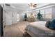 Serene bedroom with tray ceilings, plush rug, and abundant natural light from multiple windows at 10115 Paxton Run Rd, Charlotte, NC 28277