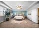Tranquil bedroom featuring a tray ceiling, accent wall, and ample natural light at 10115 Paxton Run Rd, Charlotte, NC 28277