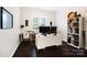 Bright office with a large desk, two monitors, and wood floors at 10115 Paxton Run Rd, Charlotte, NC 28277