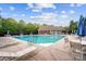 Community pool area with lounge chairs, tables, umbrellas, and well-maintained surroundings at 10115 Paxton Run Rd, Charlotte, NC 28277