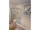 Bright bathroom features a glass-enclosed shower and a luxurious soaking tub with stylish wall art at 12244 Wallace Ridge Dr, Charlotte, NC 28269