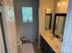 Bathroom with double sinks, a large vanity, and a separate tub at 12244 Wallace Ridge Dr, Charlotte, NC 28269