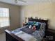 This bedroom has a large window with plenty of natural light and a ceiling fan at 12244 Wallace Ridge Dr, Charlotte, NC 28269