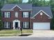 Traditional two-story brick home with a well-manicured lawn and a two-car garage at 12244 Wallace Ridge Dr, Charlotte, NC 28269