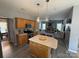 Well-lit kitchen with a center island, oak cabinets and stainless steel appliances at 12244 Wallace Ridge Dr, Charlotte, NC 28269