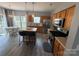 Bright eat-in kitchen featuring a center island, stainless appliances, and wood cabinets at 12244 Wallace Ridge Dr, Charlotte, NC 28269