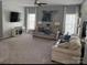 Comfortable living room with neutral colors, plush seating, and brick accent wall at 12244 Wallace Ridge Dr, Charlotte, NC 28269