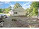 View of a residential backyard featuring a detached garage, lawn, and some foliage at 124 10Th Sw St, Conover, NC 28613