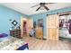 Cozy bedroom with barn door to bath, blue walls, wood flooring, and plenty of decor at 124 10Th Sw St, Conover, NC 28613