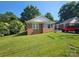 Charming single-story brick home with a well-maintained lawn, mature trees, and sunny blue skies at 124 10Th Sw St, Conover, NC 28613
