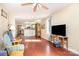 Spacious living room with hardwood floors, a ceiling fan, and an open layout connecting to the kitchen area at 124 10Th Sw St, Conover, NC 28613