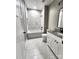 Bright bathroom with white marble-style tiled shower/tub and granite vanity at 1247 Beltline Rd # 1, Chester, SC 29706