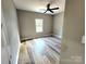 Neutral bedroom with wood-look flooring, ceiling fan, and window providing natural light at 1247 Beltline Rd # 1, Chester, SC 29706