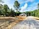A new house with a partially complete front yard and driveway, surrounded by lush, tall trees at 1247 Beltline Rd # 1, Chester, SC 29706