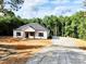 Charming single-story home with a large front yard and newly paved driveway, surrounded by lush greenery at 1247 Beltline Rd # 1, Chester, SC 29706