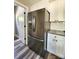 Stainless steel refrigerator next to white cabinets, granite countertops, and tile backsplash in a well-lit kitchen at 1247 Beltline Rd # 1, Chester, SC 29706