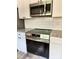 Modern kitchen with stainless steel appliances, granite countertops, white cabinets, and a stylish backsplash at 1247 Beltline Rd # 1, Chester, SC 29706