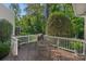 Outdoor deck with dining table, chairs, string lights and mature landscaping at 1400 Coachman Dr, Waxhaw, NC 28173
