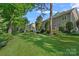 Spacious backyard features lush green lawn and mature trees, creating a serene outdoor space at 1400 Coachman Dr, Waxhaw, NC 28173