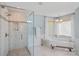 Bright bathroom featuring a walk-in shower and a soaking tub beneath a window at 1400 Coachman Dr, Waxhaw, NC 28173