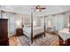 Main bedroom with four-poster bed, hardwood floors, tray ceilings, and plantation shutters at 1400 Coachman Dr, Waxhaw, NC 28173