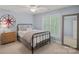 Comfortable bedroom with large compass decoration, shuttered window, mirror and neutral paint at 1400 Coachman Dr, Waxhaw, NC 28173