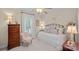 Charming bedroom features a decorative metal bed frame, shuttered window, and neutral color palette at 1400 Coachman Dr, Waxhaw, NC 28173