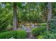 Secluded firepit area with comfortable seating, set amidst mature trees and landscaping at 1400 Coachman Dr, Waxhaw, NC 28173