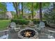 Cozy stone firepit with Adirondack chairs, creating a relaxing outdoor space at 1400 Coachman Dr, Waxhaw, NC 28173