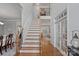 Inviting foyer with hardwood floors, a staircase with wooden handrails, and a view into multiple rooms at 1400 Coachman Dr, Waxhaw, NC 28173