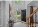 Bright foyer with hardwood floors, soaring ceilings, an elegant staircase, and a view of the front yard at 1400 Coachman Dr, Waxhaw, NC 28173